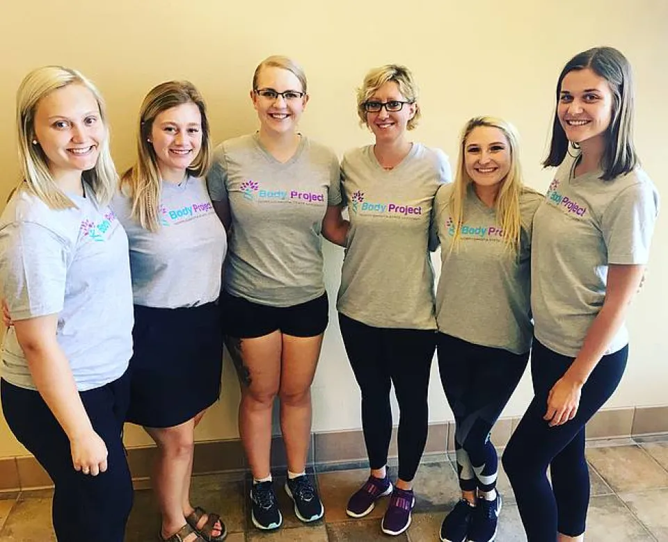 A group of women smiling confidently at camera.