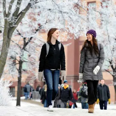 students walking through campus during the winter