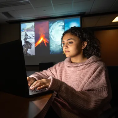 Emergency Management student working on a laptop