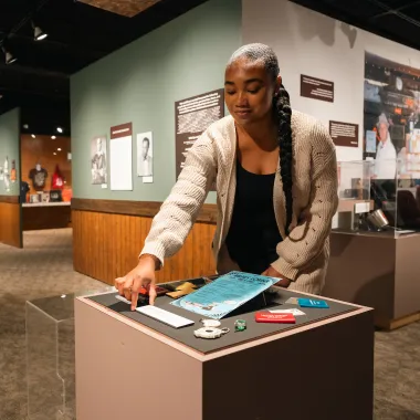 student positioning artifacts for an exhibit in a museum