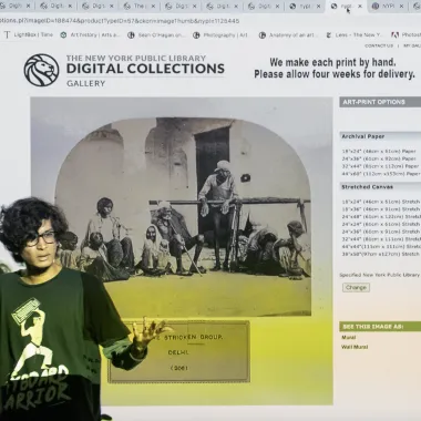 Anshul Roy stands in front of screen featuring an archive of colonial photographs. This image links to the artists website.