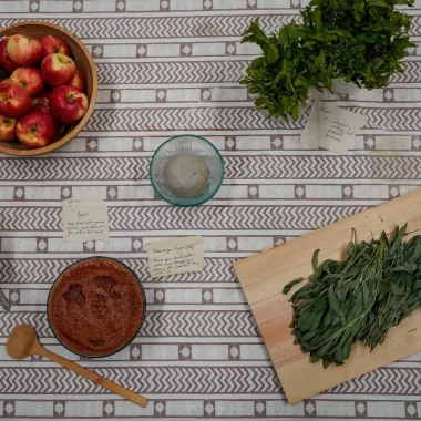 A table full of fruits and foods with notes beside them. This image links to the artists website.