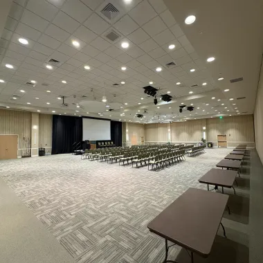 Ballroom A side with row seating and tables in the back