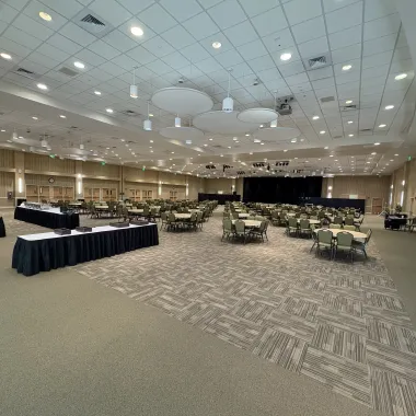 Oceti Sakowin Ballroom arranged with round tables for banquet