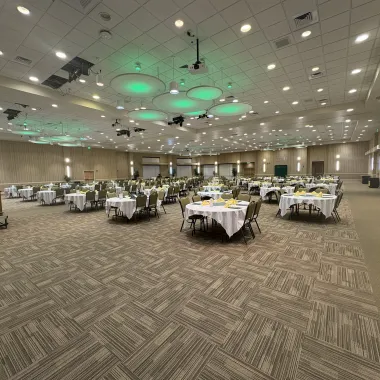Oceti Sakowin Ballroom arranged with round tables for banquet