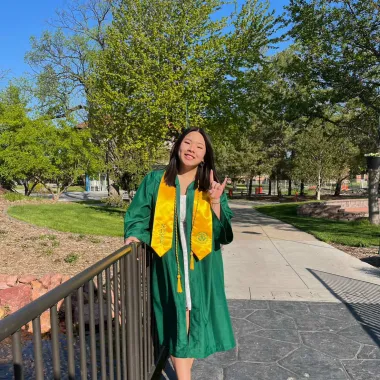 graduate standing near the Babbling Brook