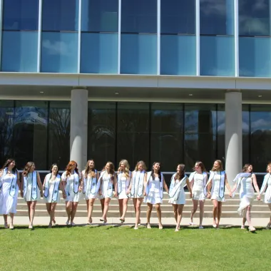 group of students gather outside of A. Glenn Hill for a photo prior to commencement