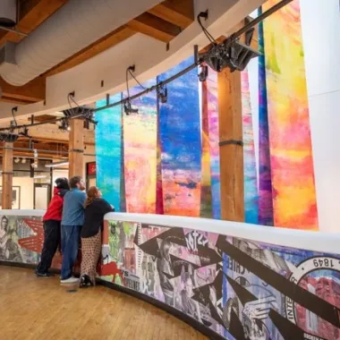 People looking at an art exhibit at the Plains Art Museum