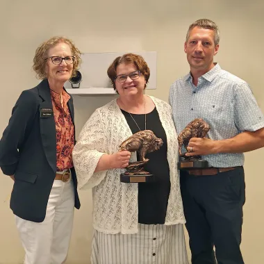 Pam Gulleson with exiting members, Julie Zikmund and Doug Bichler