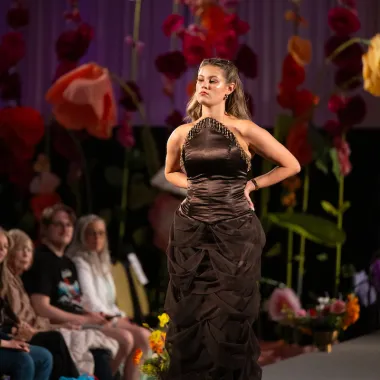 Model wearing brown floor-length dress.