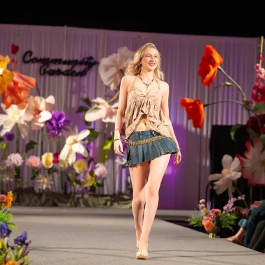 Model wearing a sleeveless shirt and skirt.