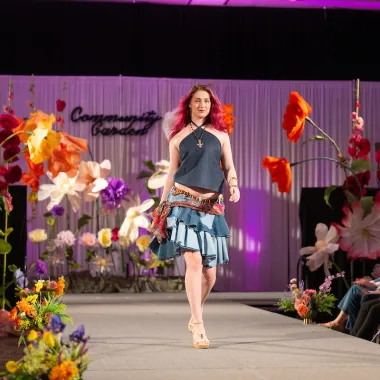 Model wearing a sleeveless shirt and knee-length skirt.