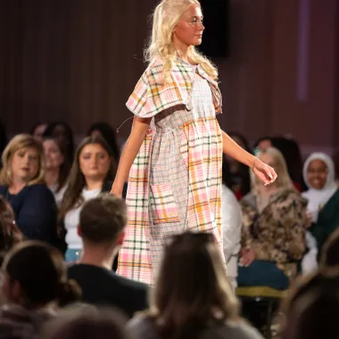 Model wearing a plaid dress.