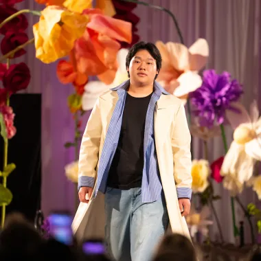 Model wearing jeans and long jacket.