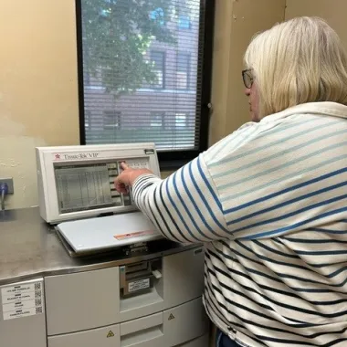 Lab manager uses machine.