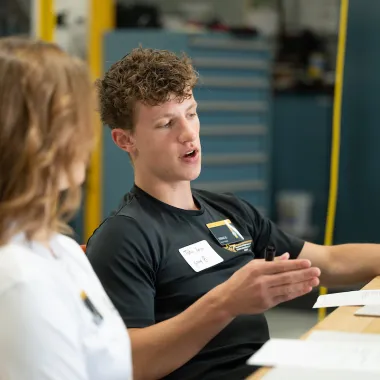 NDSU Honors College student Tobias Berge talking to another member of the cohort.