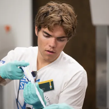 NDSU Honors College student Joseph Churchill uses a pipette during an Honors College activity.