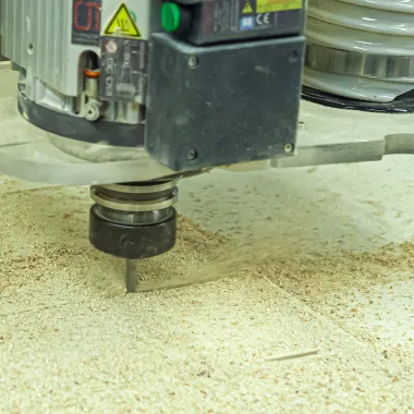 Machine cutting wood in woodship.