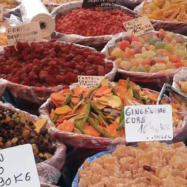 Various international foods in bowls at market.