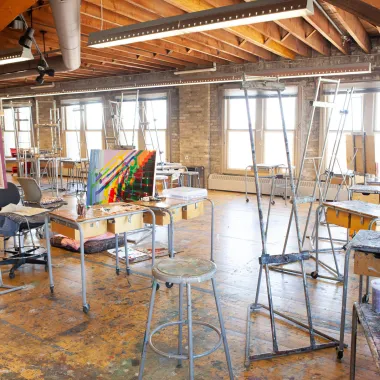 Chairs, tables and easels located in painting studio.