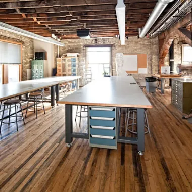 Tables and stools located in the printmaking studio.