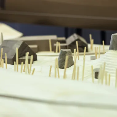 Woodshop model with buildings and sticks.