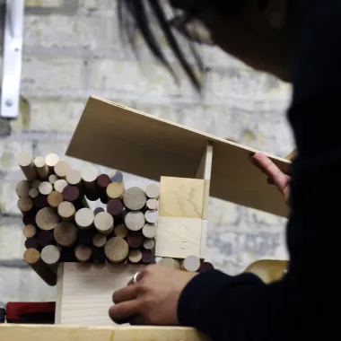 Student working with wood in woodshop.