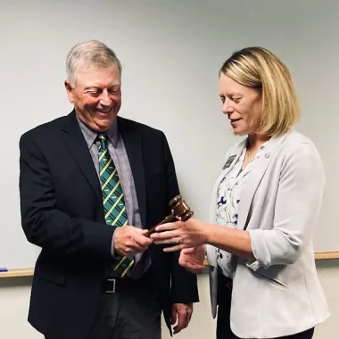 Mark Birdsall handing the gavel over to Sarah Lovas