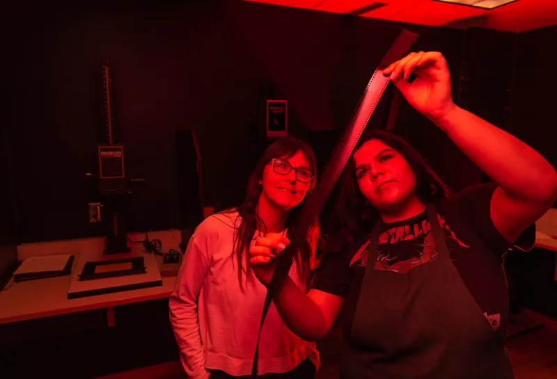Students working in the photography studio darkroom