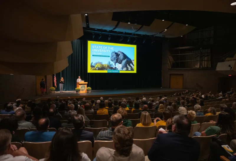 Audience in theater for the 2024 homecoming State of the University speech