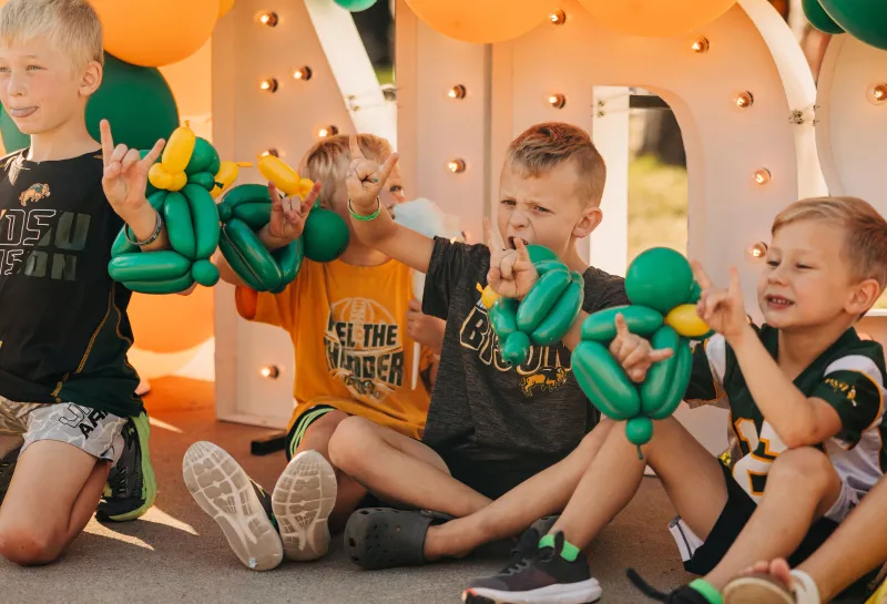 Children wearing balloon bracelets during 2024 Homecoming parade