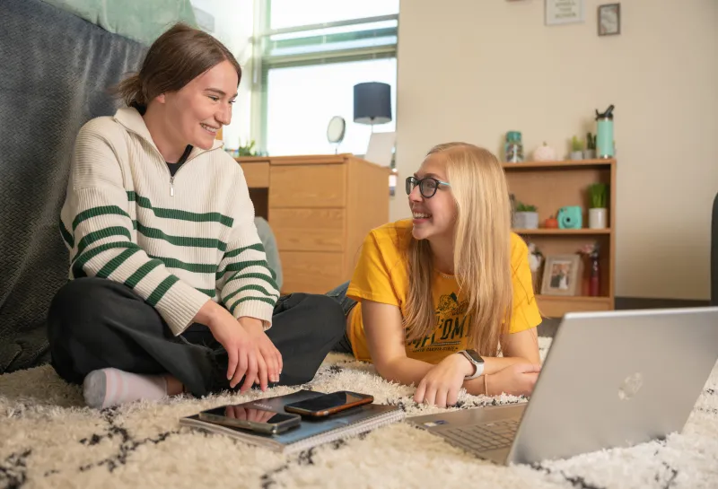 two roommates hanging out in their dorm room