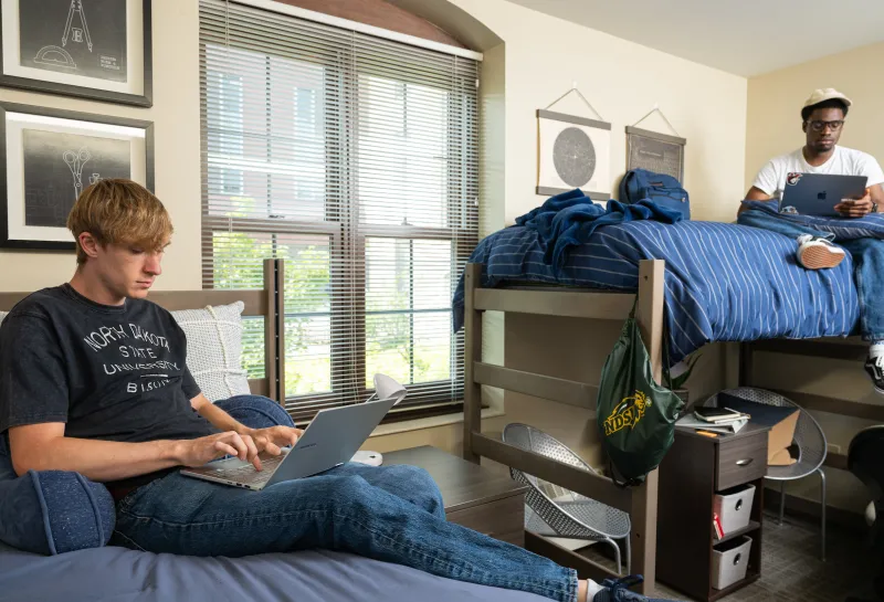 Two residents working in their room at Churchill.