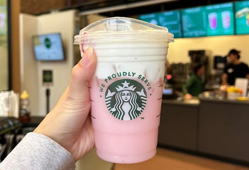 Student holding a Starbucks drink available at Minard Coffee Shop