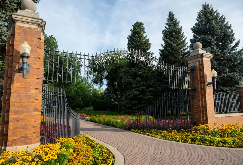 View of NDSU East Entrance Gate with blooming flowers