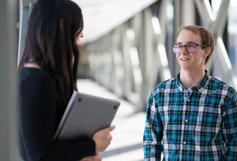 students speaking in a hallway
