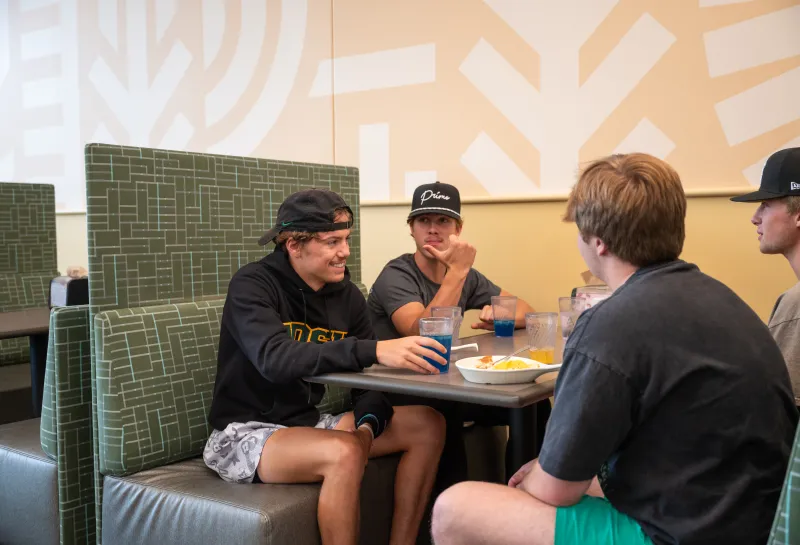 Students in a booth having lunch at West Dining Center