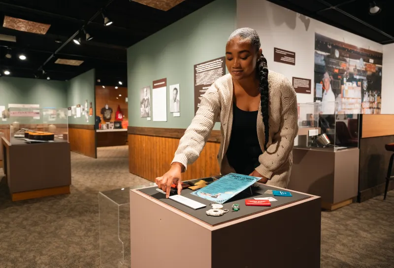 student positioning artifacts for an exhibit in a museum