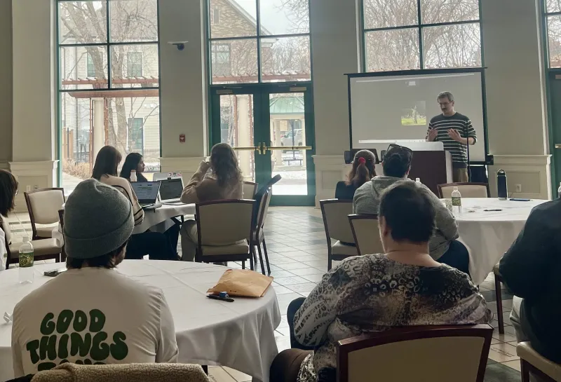 Students sitting listening to speaker.
