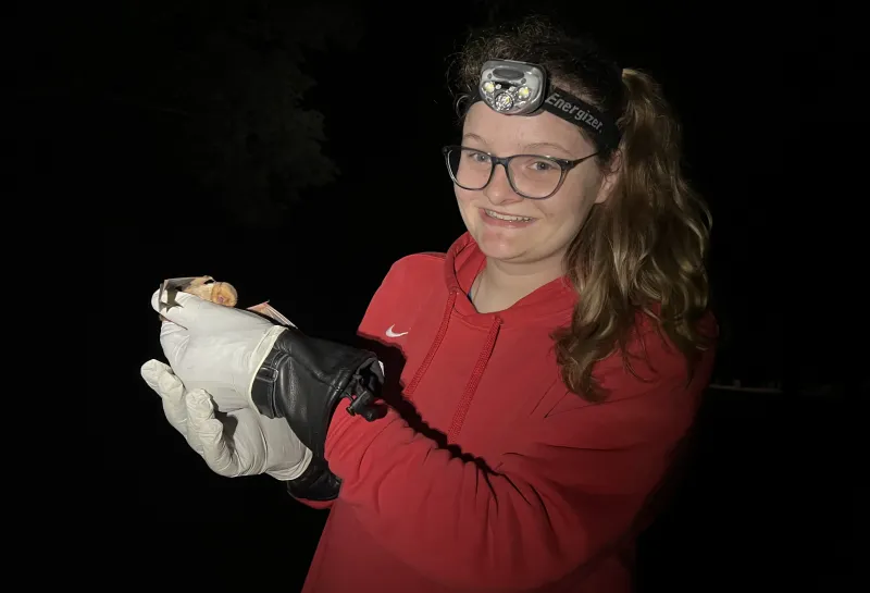 Karliegh wearing gloves and holding a bat.