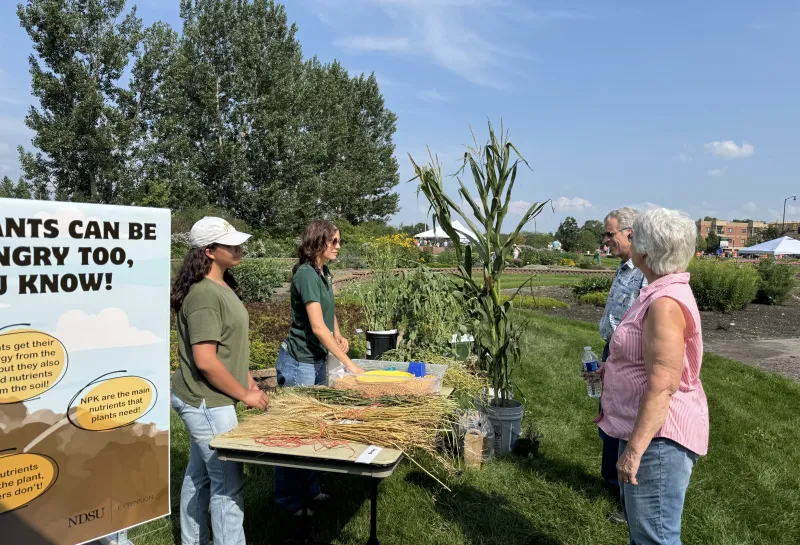 students discuss agronomic crops with guests