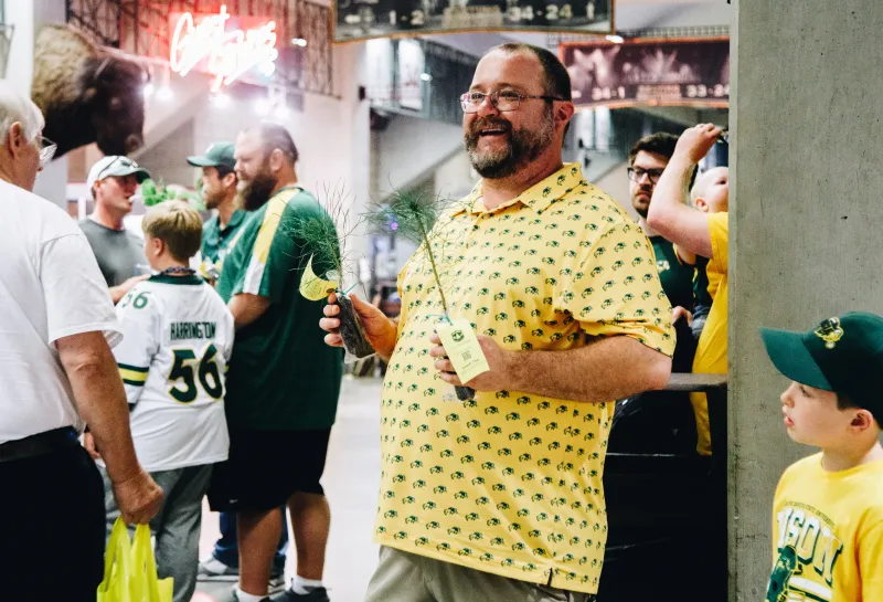 A man handing out a tree