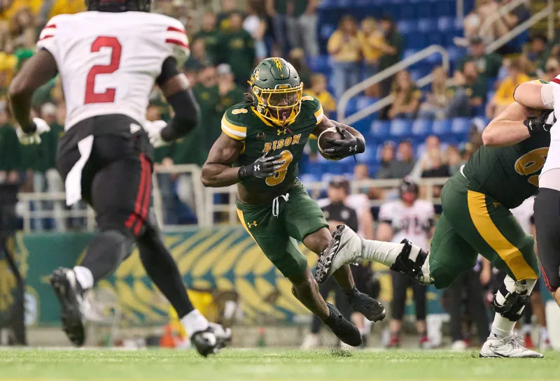 NDSU football player runs the ball down the field