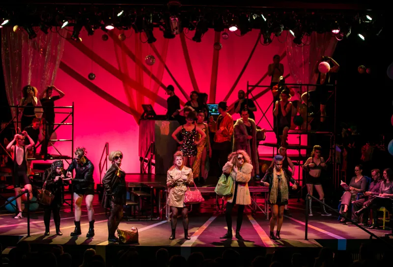 An ensemble of actors performing on stage in a Theatre NDSU production.