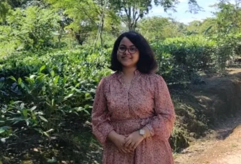 Sukanya smiling confidently at camera.