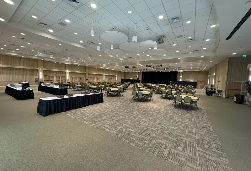 Oceti Sakowin Ballroom arranged with round tables for banquet