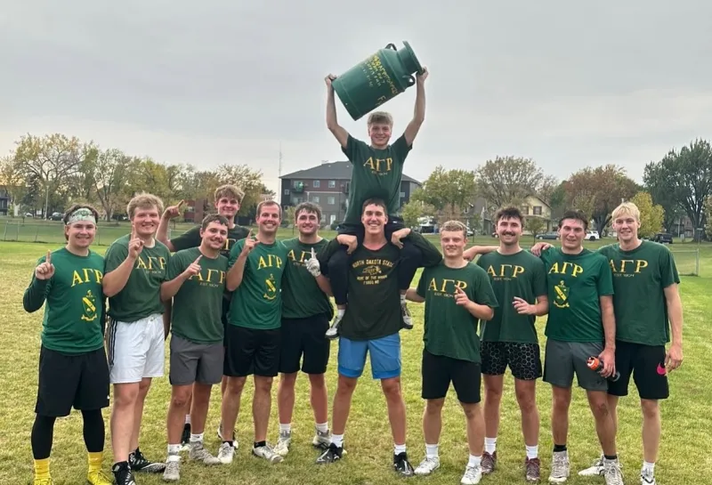 AGR students holding barrel