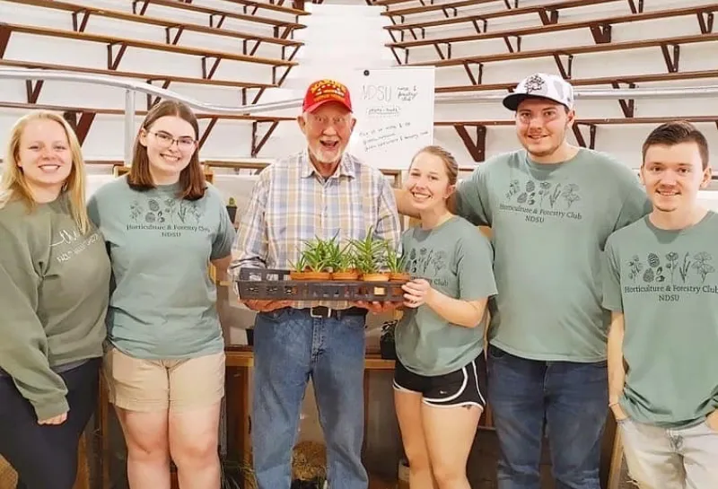 horticulture club students holding plants