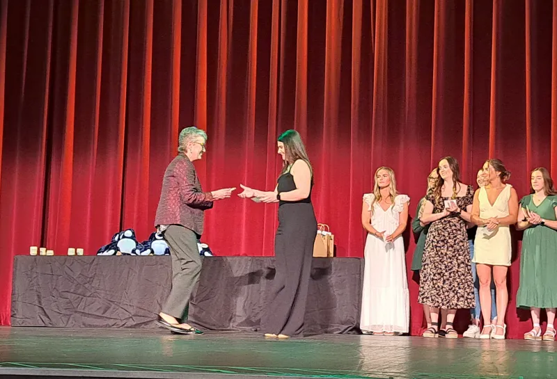 Student receiving award on stage at the Spring 2024 SoDAA Sendoff.