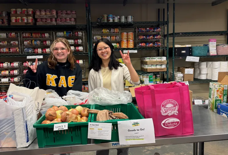 Students posing in the Goods for the Herd Food Pantry
